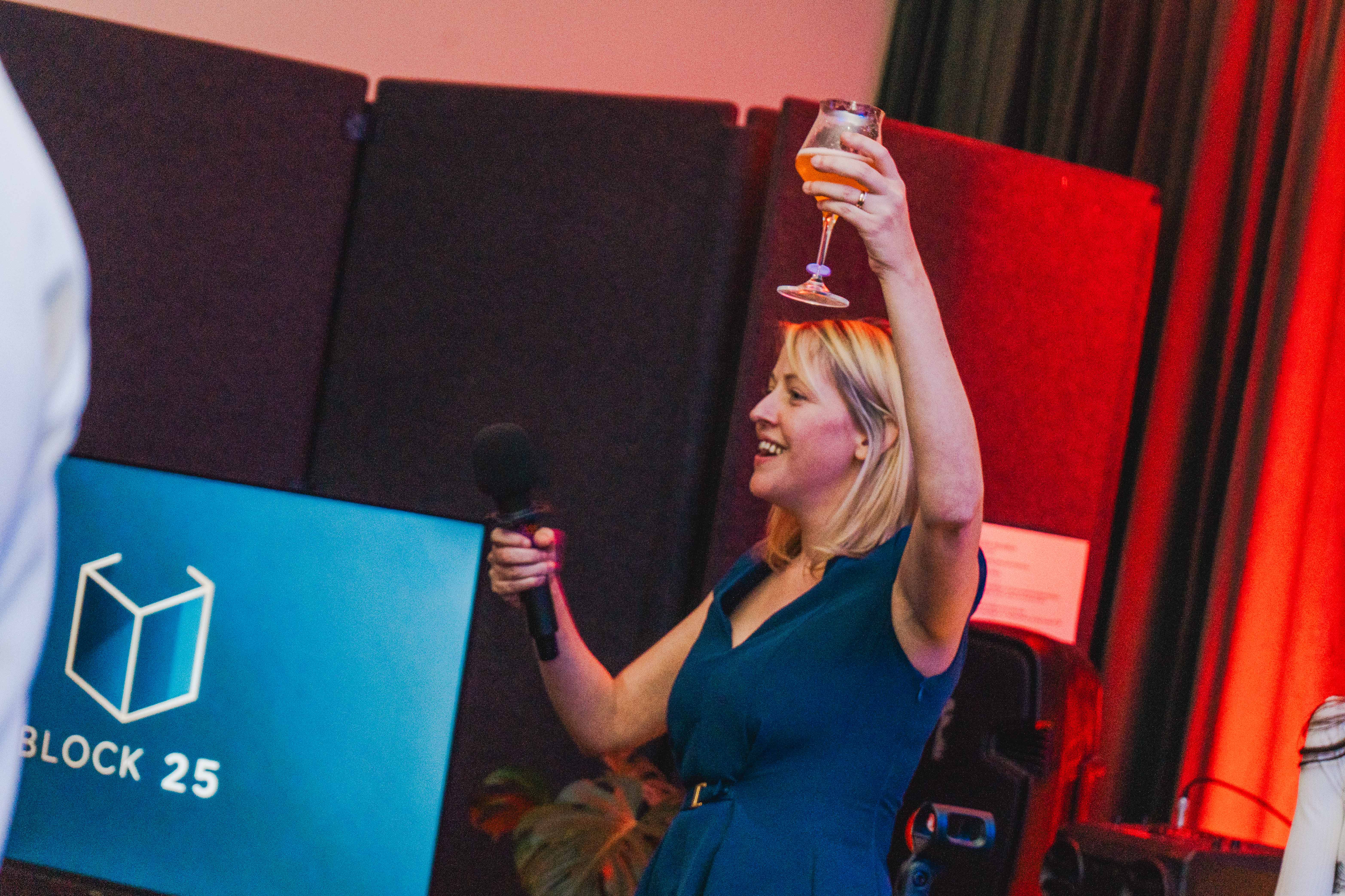 BLOCK25 attendee raising glass in toast